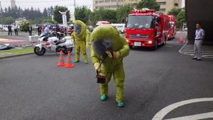 陽圧式化学防護服を着装した救助隊が環境を測定する